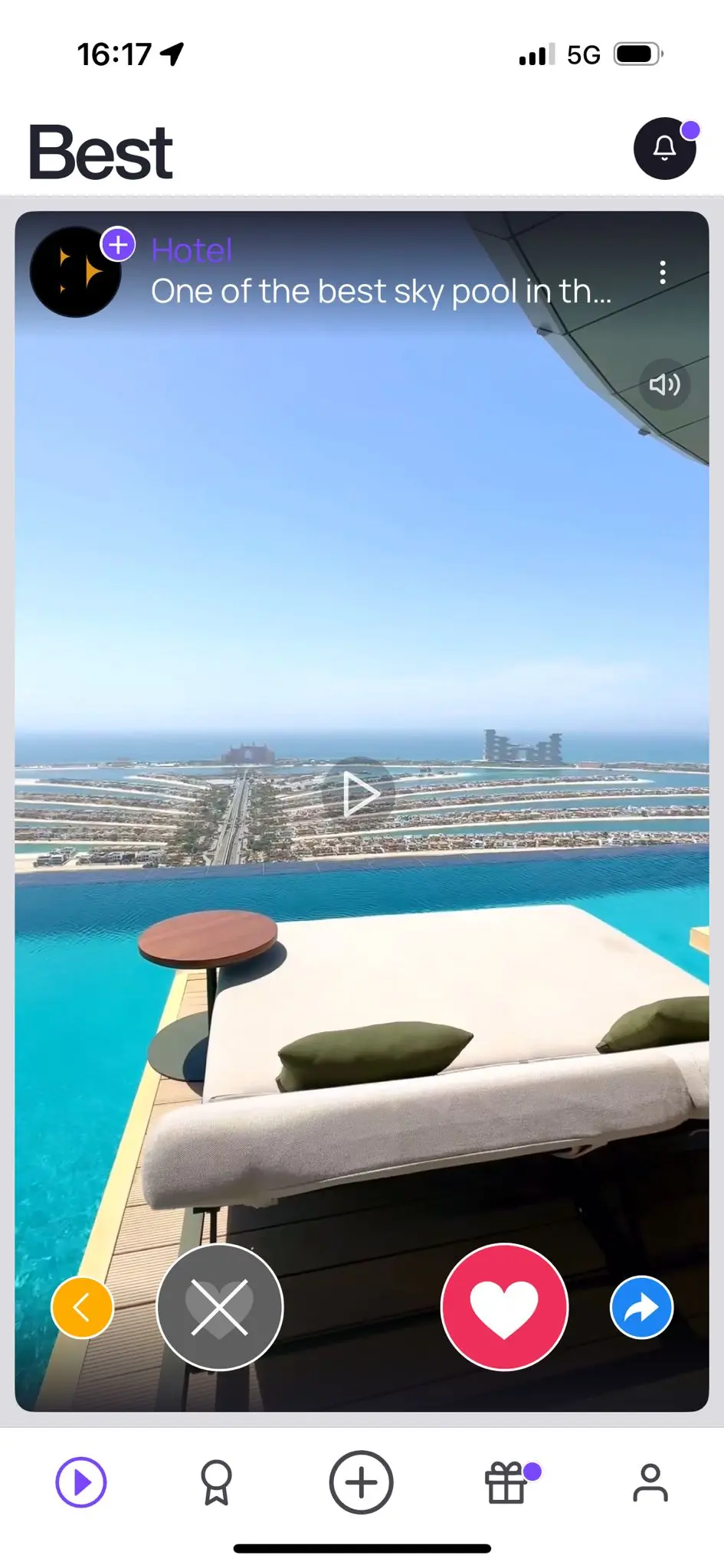 The Best app's video feed, showing a hotel rooftop pool with the heart and cross vote buttons